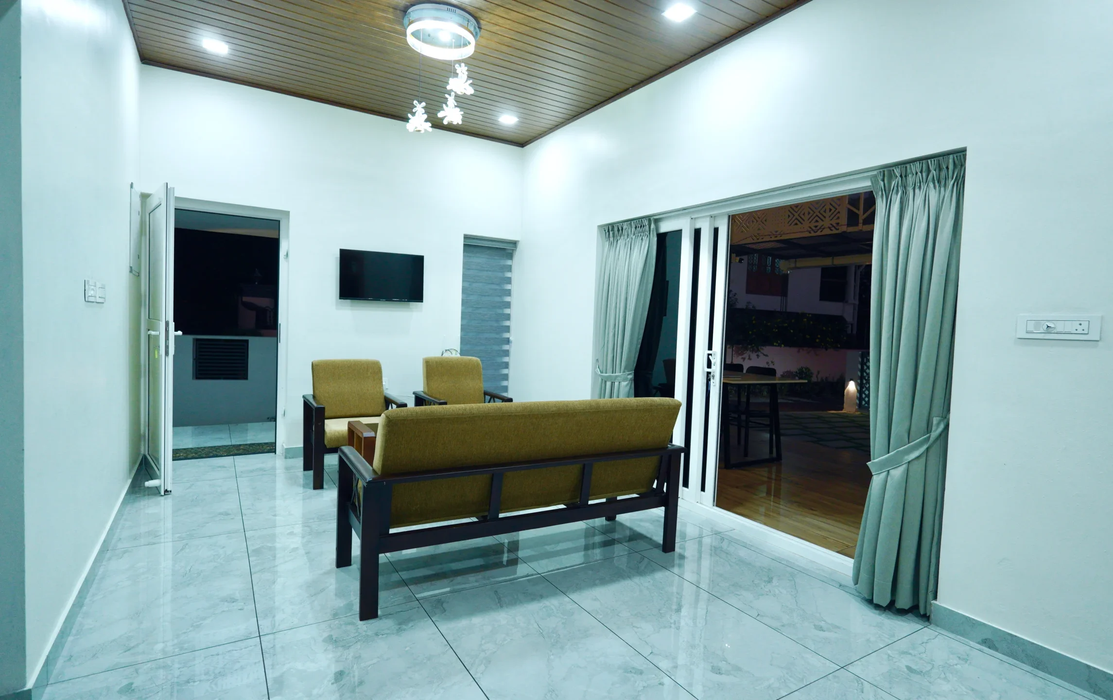 Elegant living room in private pool villa Kochi with stylish seating and cozy ambiance